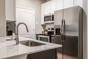 A kitchen with stainless steel appliances and a sink